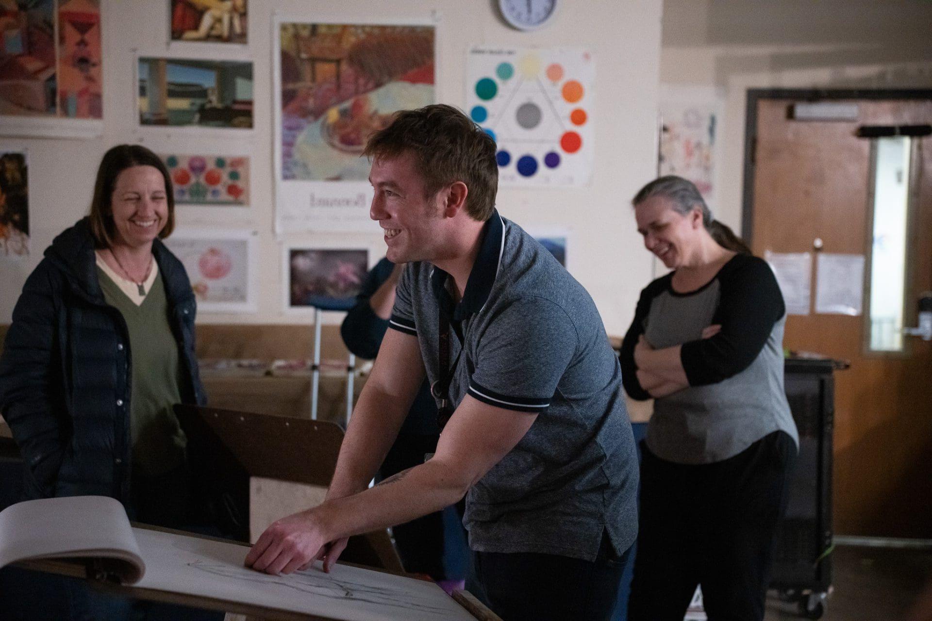 People laughing in an art class setting.